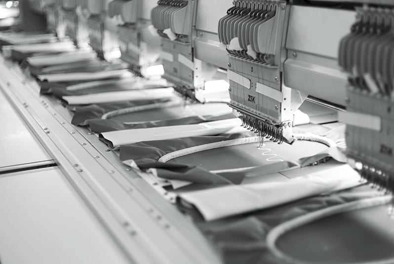 Embroidery heads working along a production line