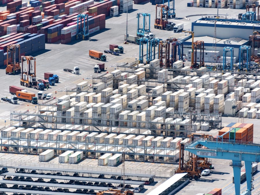 An aerial view of a container terminal with straddle carriers
