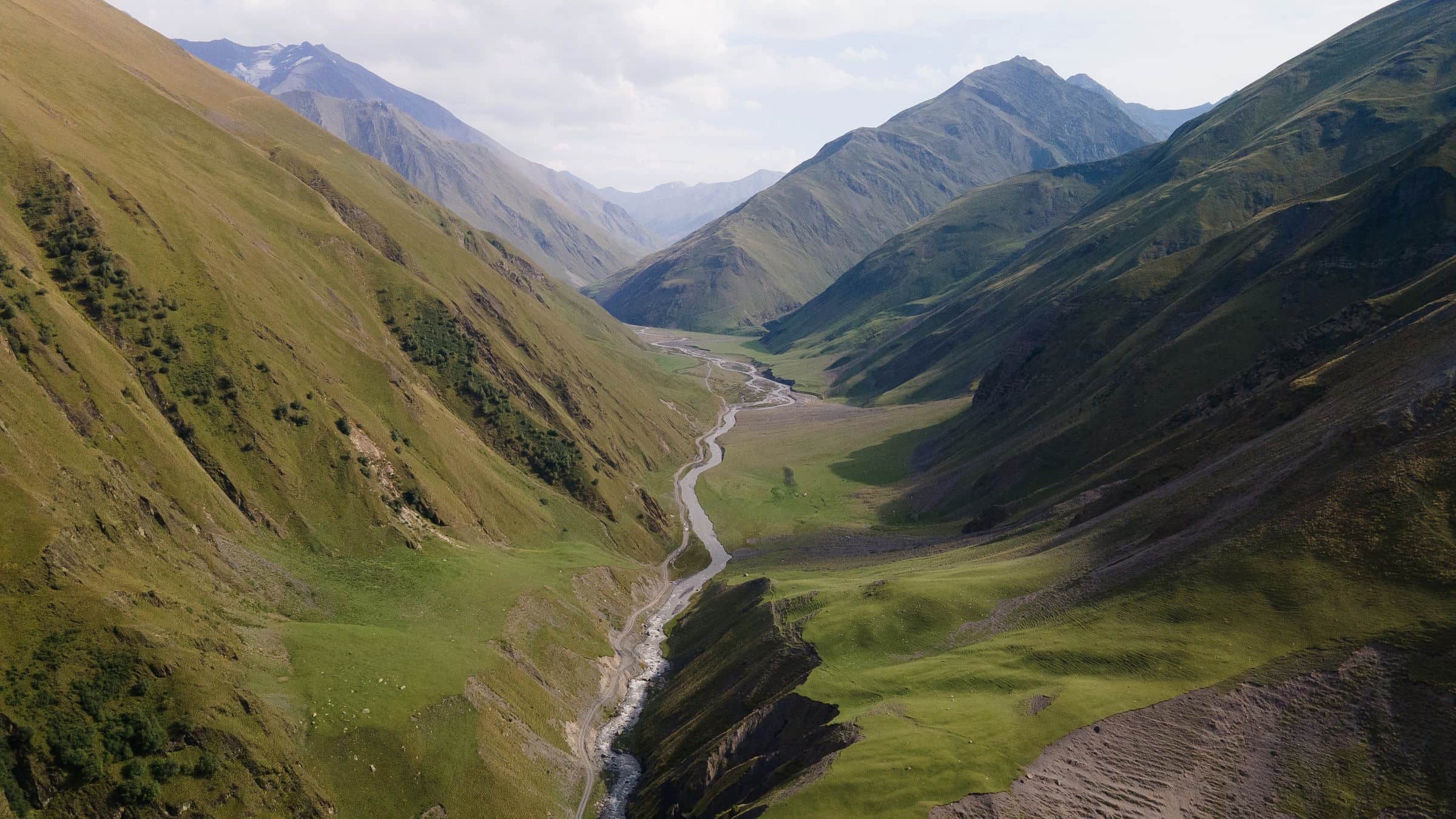 A green mountain valley with a river, seen from the air, Dagestan