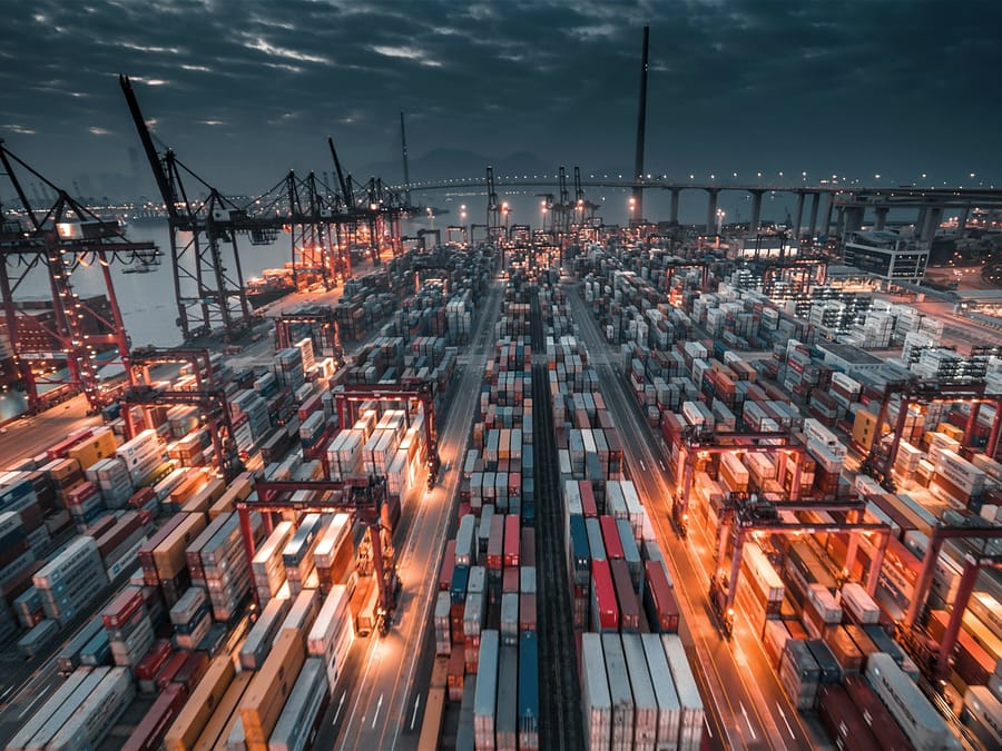 Container port and gantry cranes under a dark sky, Hong Kong